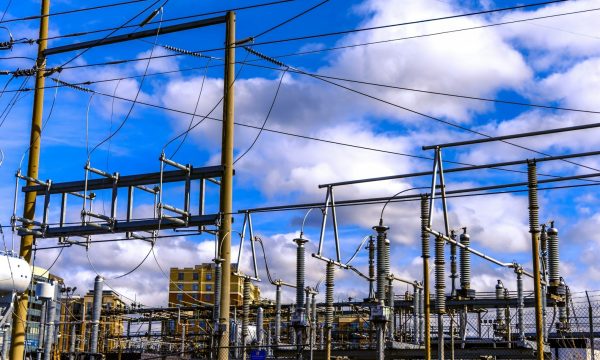 a photo of power lines illustrates an op-ed on drone infrastructure inspection